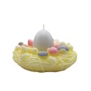 Osternestkerze, Kerze in Osternest aus Wachs, Eikerze wei&szlig;, Nest in gelb, Geschenkverpackung mit rosa Schleife, 13  x 7 cm 